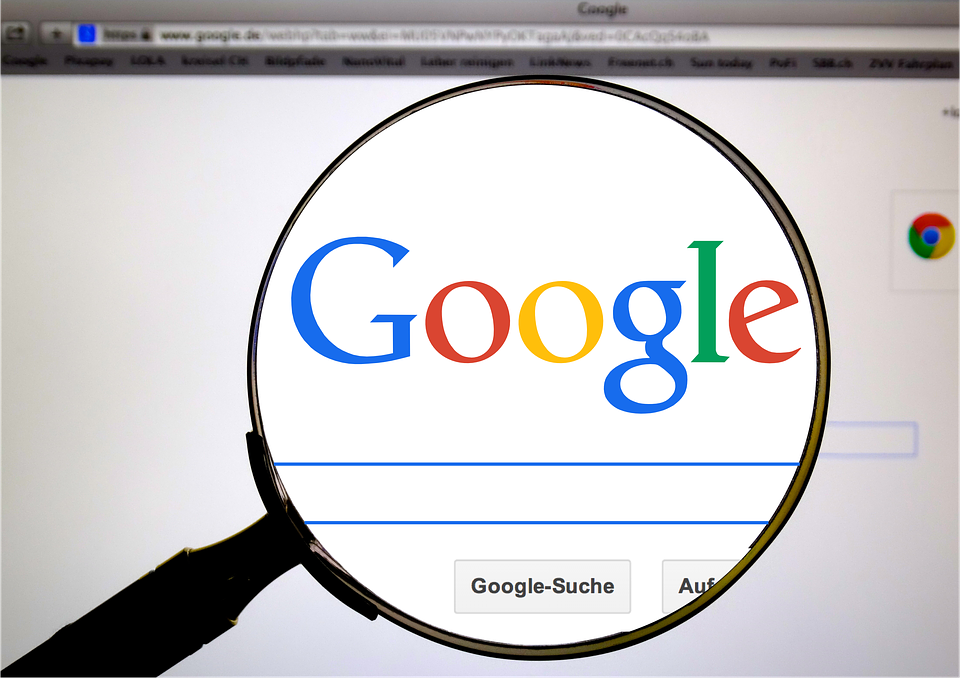 Google search engine page with a magnifying glass in front of it