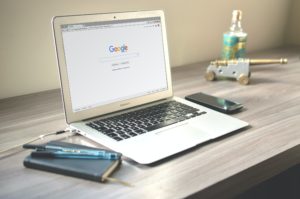 laptop on desk with google search open