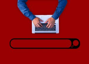 hands on a keyboard with a search bar below