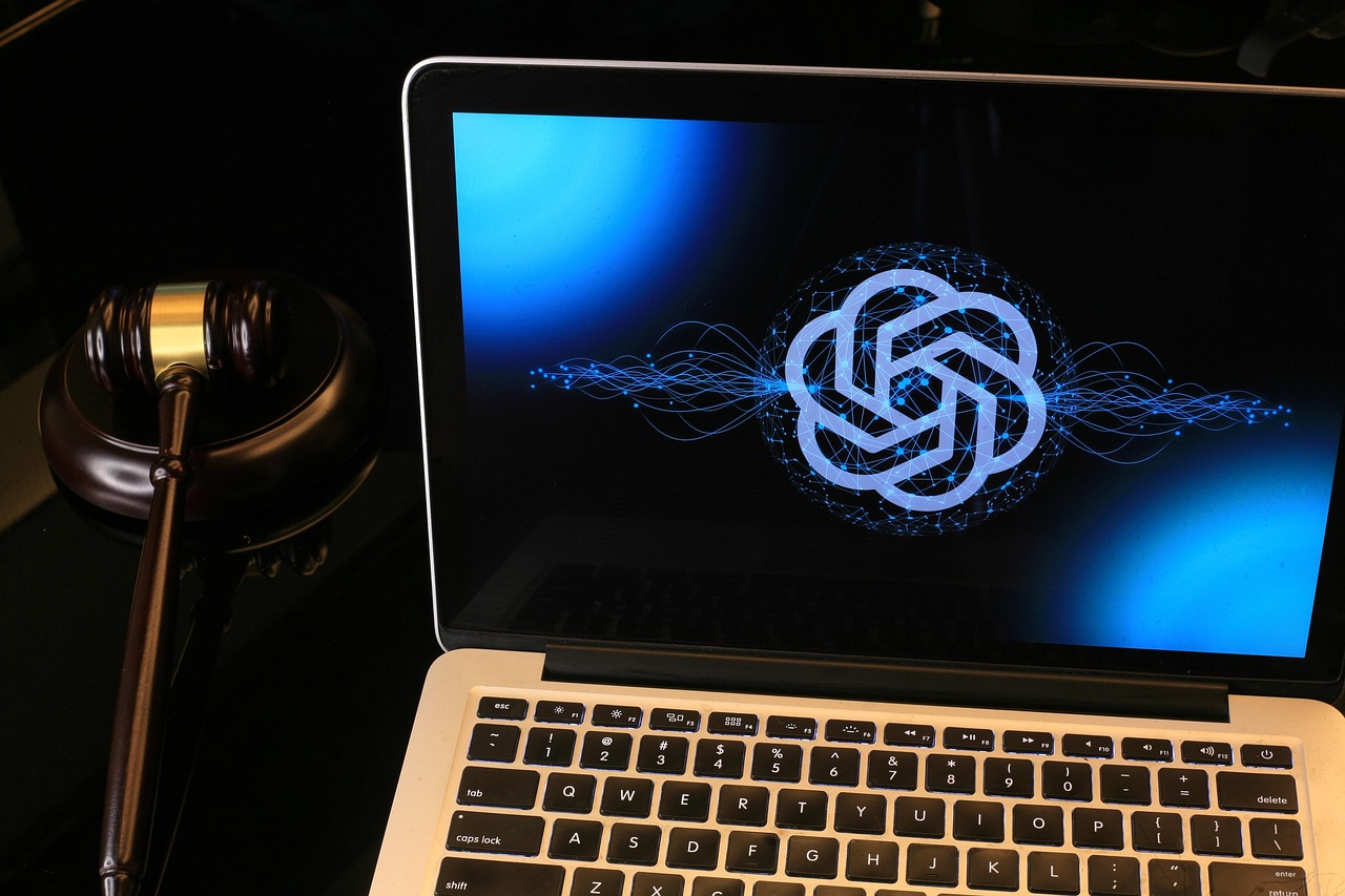 chatgpt logo on laptop next to gavel
